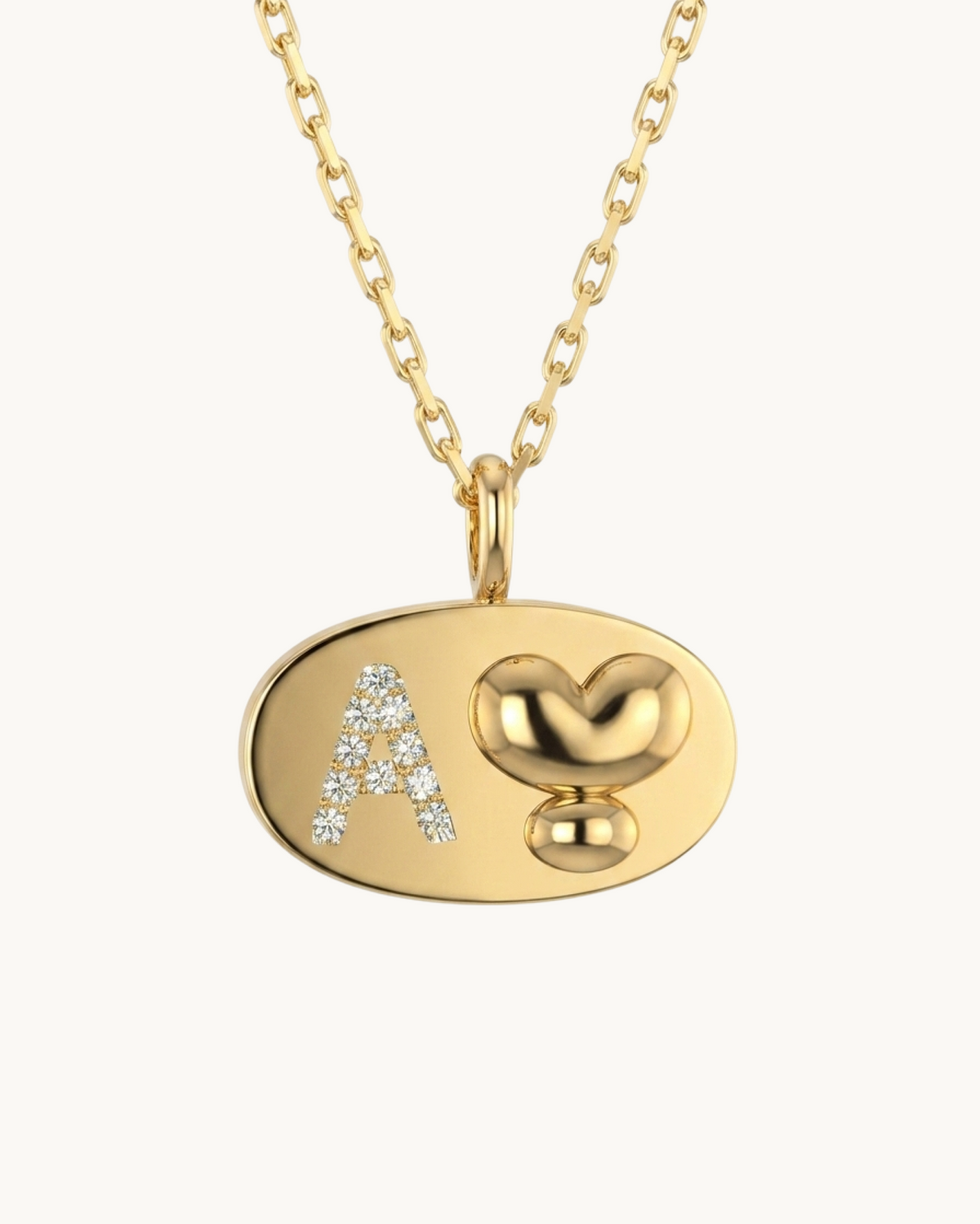 Omnia Medallion, an oval 14K gold-plated pendant on a chain with the letter A and a heart set with moissanite
